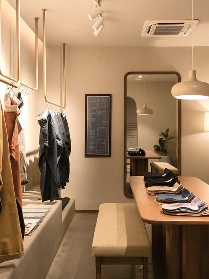The retail area at Bombay Shirt Company is designed with a focus on simplicity and quality materials, creating a serene shopping experience.