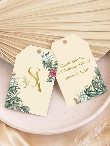 Small tags, big impressions. These custom gift tags feature a tropical leaf design and a gold foil monogram, perfect for adding a touch of magic to wedding favors and thank you gifts.