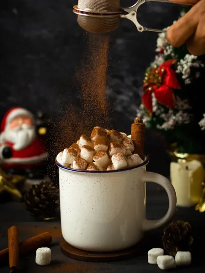 A classic hot chocolate shot from the archives. The action of dusting cocoa powder over marshmallows adds a dynamic feel to this cozy Christmas scene.