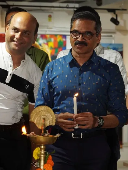 A candid moment during the lamp lighting ceremony at the 'Sanskruti Yatra' exhibition.