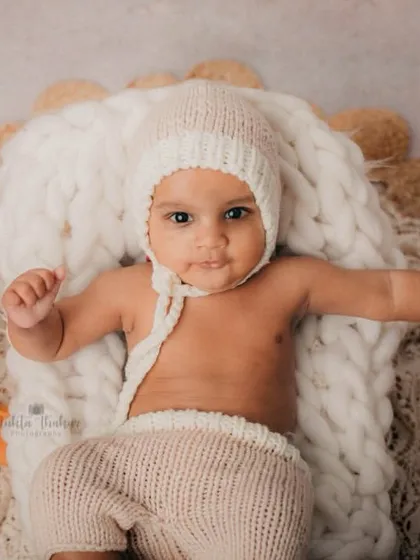 Posing with his teddy bear, this 4-month-old is the star of his boho-themed session.