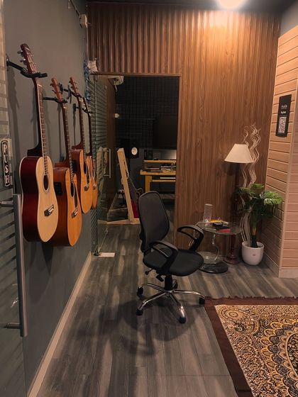 A look down the hallway of our studio, with a line of acoustic guitars ready for students to use during their lessons.