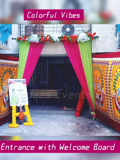 The first impression matters, and I make sure the entrance to your event is just as beautiful as the main decor. Here, a traditional Haldi ceremony entrance is decorated with bright pink and lime green drapes, a floral header, and flanked by panels with peacock motifs. A personalized welcome board on a marigold-wrapped stand greets the guests.