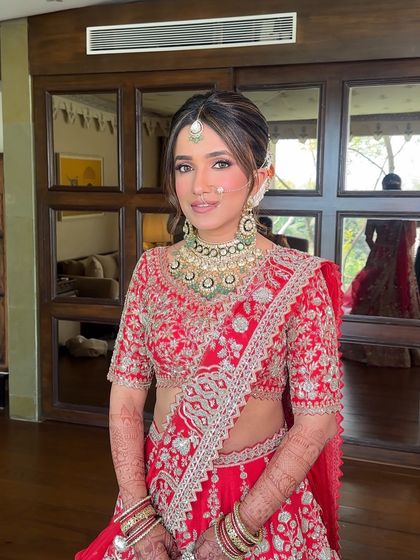 A radiant bride smiling, her floral bun peeking out from the side. This look is perfect for a daytime wedding, feeling fresh, romantic, and effortlessly beautiful.