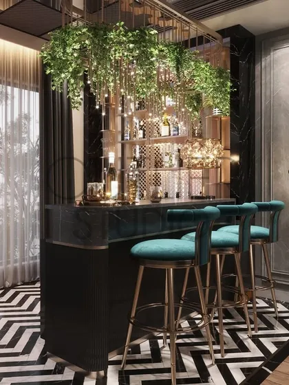 This bar area is a statement in itself, with a dramatic black and white chevron floor, a bar adorned with hanging greenery, and a quirky floor lamp, creating an experience with every cocktail.