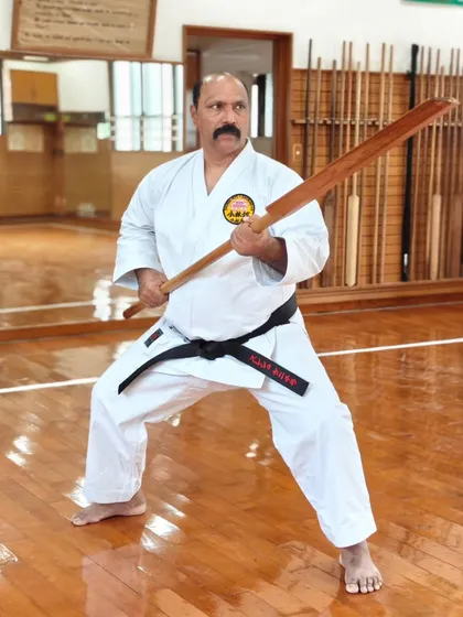 Kobudo, the art of Okinawan weapons, is an integral part of our curriculum. This is me demonstrating a stance with a traditional Eku (oar), a practice that develops strength, coordination, and a deeper understanding of martial principles beyond empty-hand techniques.
