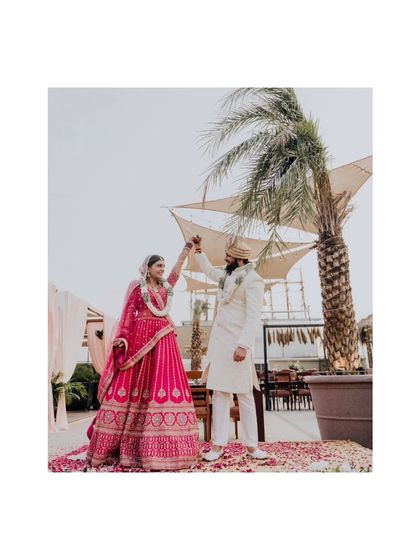 A fun, dancing portrait of the couple on the beach after their wedding ceremony.