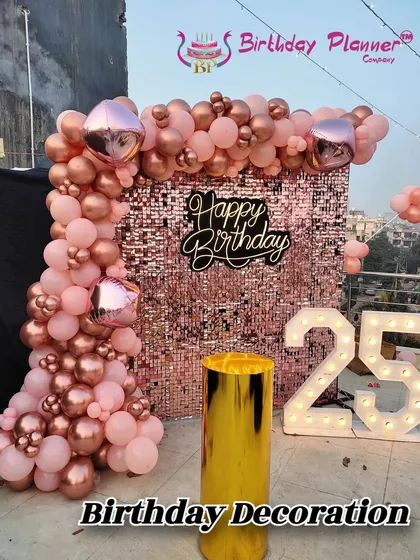 Celebrating a 25th birthday in style with a glamorous rose gold theme. The shimmering sequin wall creates a perfect photo opportunity, complemented by a matching organic balloon garland and bold, illuminated marquee numbers.