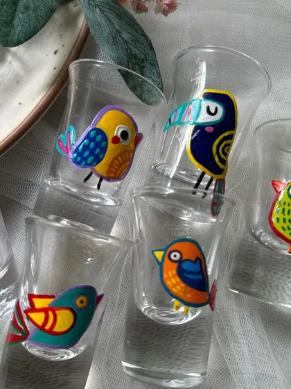 The full set of bird-themed shot glasses, each with a unique character.
