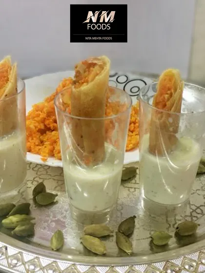 A creative take on a classic dessert. These are Gajar Halwa spring rolls, served with a side of rabri for dipping. It's a unique fusion dessert that combines crispy texture with warm, familiar flavors.