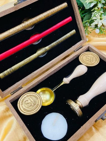 A close-up of our personalised wax seal stamp kit. The wooden box can also be engraved with your logo or monogram.