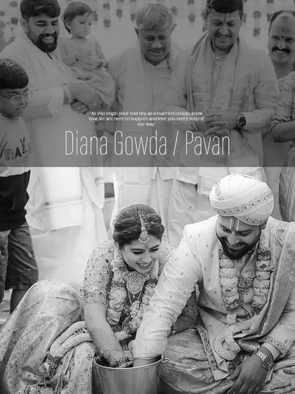 A candid, black and white shot of the couple during a wedding ritual. Even in monochrome, the texture and fit of the groom's custom sherwani and the detail on his turban are apparent.