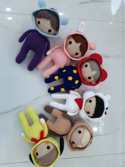 Another arrangement of the BTS-inspired dolls, showing the variety of colors and animal hoods in the collection.