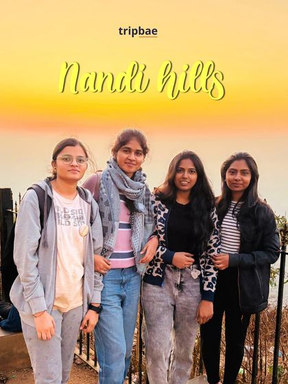 A group of friends posing against the beautiful golden sunrise at Nandi Hills. It's one of the most popular and accessible sunrise spots near Bangalore.