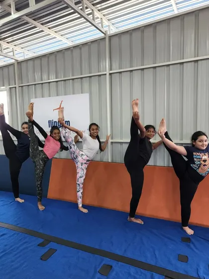 Look at that flexibility. We work together on skills like standing splits, and it's amazing to see the kids support each other and celebrate their progress as a team.