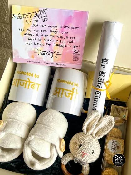 Announcing a pregnancy is pure magic. I designed this special reveal hamper for a client to surprise the grandparents-to-be with personalized mugs, tiny baby booties, and a custom 'Le Bébé Times' announcement scroll.