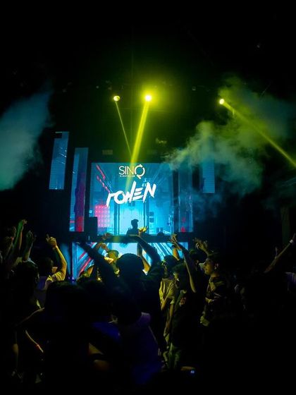 A silhouette of me against the LED screen at SinQ, Goa, with the crowd's hands in the air.