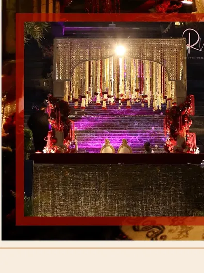 The mandap stage, with its cascading florals and dramatic lighting, creates a powerful focal point for the ceremony.