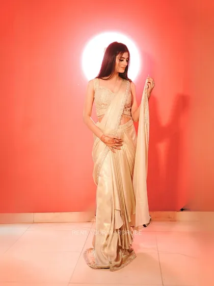 A full-length view of the golden saree, showing its modern, pre-draped silhouette.