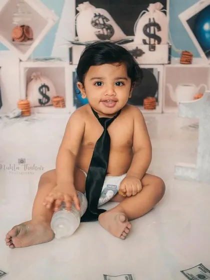 Holding his bottle like a true boss. This one-year-old had so much fun during his themed cake smash session.