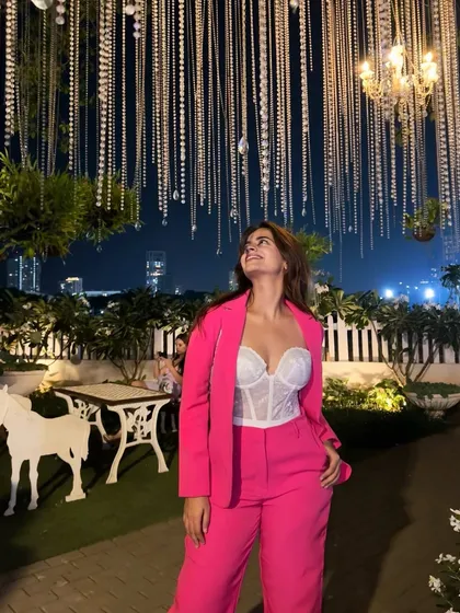 Social media isn't always the full picture. We pose and edit, but accepting your real skin and real smile is the real flex. Here I am at an event, feeling great in this pink pantsuit and corset top.