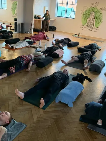 After the active part of the class, students lie down for Yoga Nidra, or yogic sleep. This practice induces deep physical, mental, and emotional relaxation, and is often accompanied by sound healing.