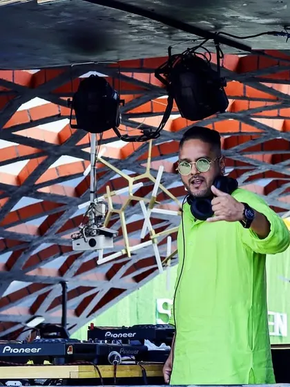 I love bringing the energy to big festival stages. Here I am, commanding the deck at a massive Holi celebration, one of my favorite themed events to play.