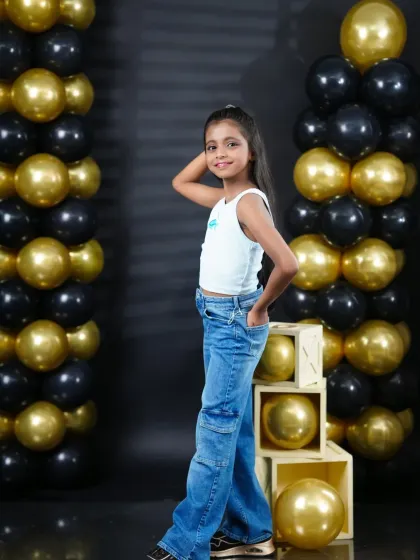 A stylish pose from a young girl during her studio birthday session, showing off her cool and confident personality.