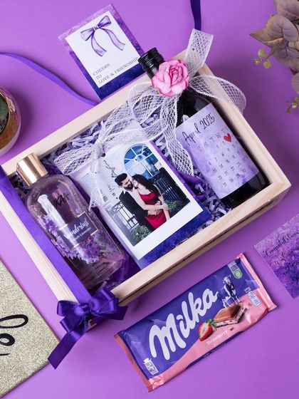An overhead shot of the bride-to-be hamper, showing how the personalized photo, wine bottle, and other goodies are arranged.