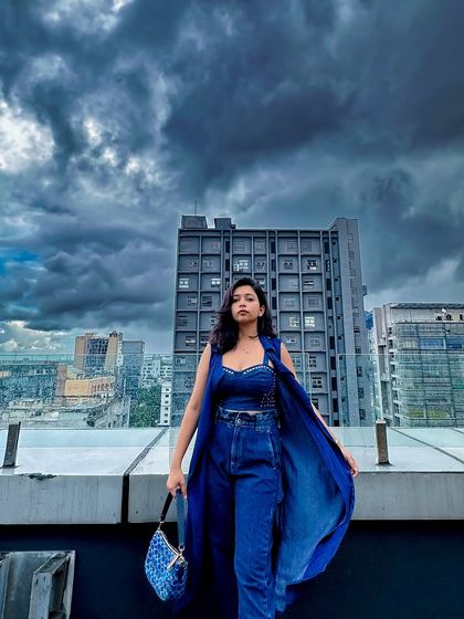 Space bound on a rainy day in Kolkata. This all-blue denim co-ord set with a long shrug looks so dramatic against the dark, cloudy sky. It's a whole mood.
