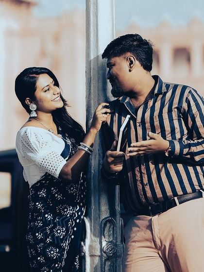 A duplicate of a couple sharing a moment by a lamppost, with the iconic Vidhana Soudha in the background.