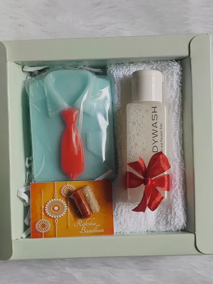 A neat and classic Rakhi hamper for a brother, containing a shirt-and-tie soap, body wash, a face towel, and a rakhi card.