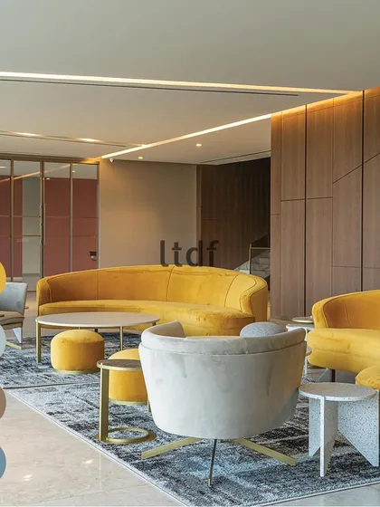 The power of color psychology in design is like a secret language. Here, vibrant yellow sofas bring a burst of energy and optimism to this lounge area, creating a cheerful and welcoming atmosphere for socializing.