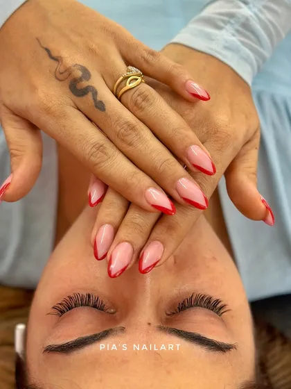 A classic red French tip is always a power move. Here we've paired it with fresh, natural-looking lash extensions for a complete glam look.