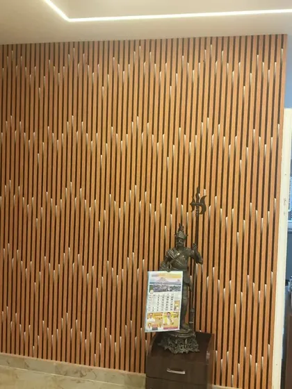 This accent wall features fluted panels arranged in a dynamic, geometric pattern. The wood finish brings warmth, while the clean vertical lines and integrated LED strip lighting create a modern and sophisticated look.