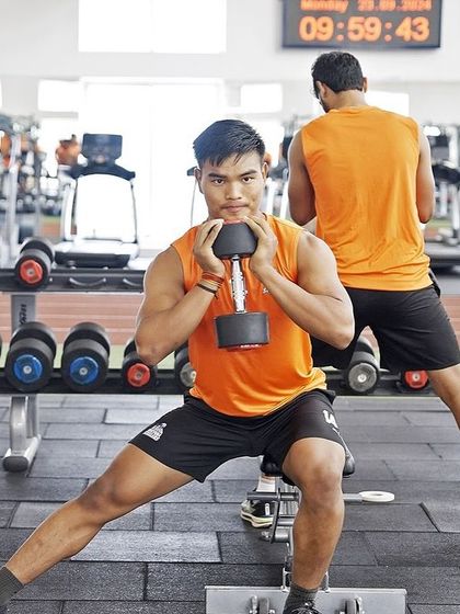 A Cossack squat in progress. This unilateral exercise is excellent for building single-leg strength, hip mobility, and adductor flexibility, all crucial for multi-directional sports.