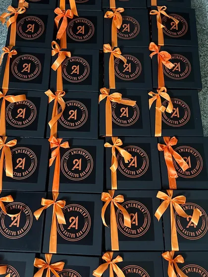 Spooky season, but make it stylish. These Halloween-themed corporate gifts for 21 Amendment Gastro Bar featured custom black boxes with striking orange ribbons.