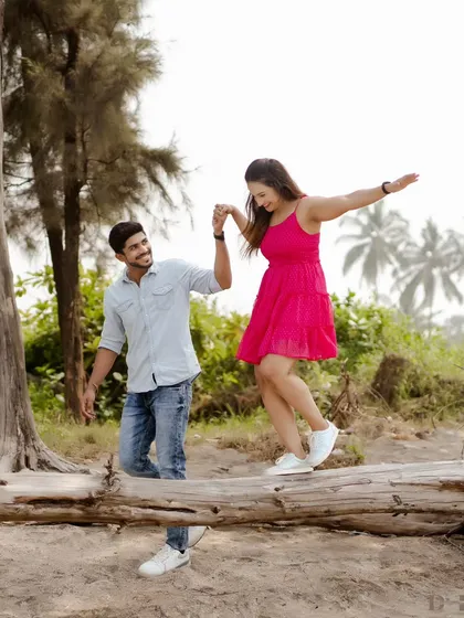 A single shot capturing the couple's perfect balance and trust as they walk along a fallen tree. It’s a metaphor for their journey together, hand in hand.