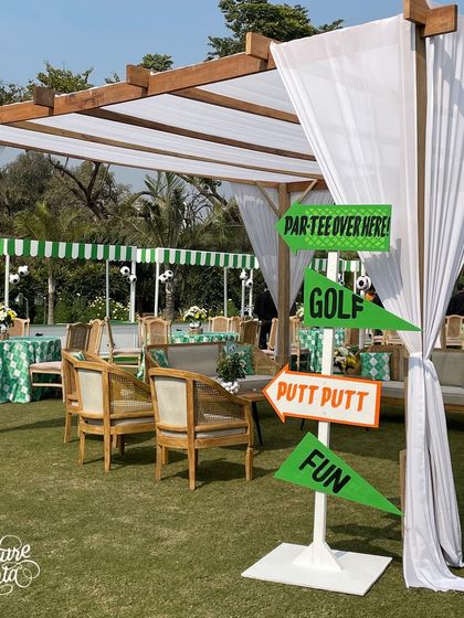 A fun signpost at the sports party directs guests to the 'Par-Tee', mini-golf ('Putt Putt'), and other fun zones.