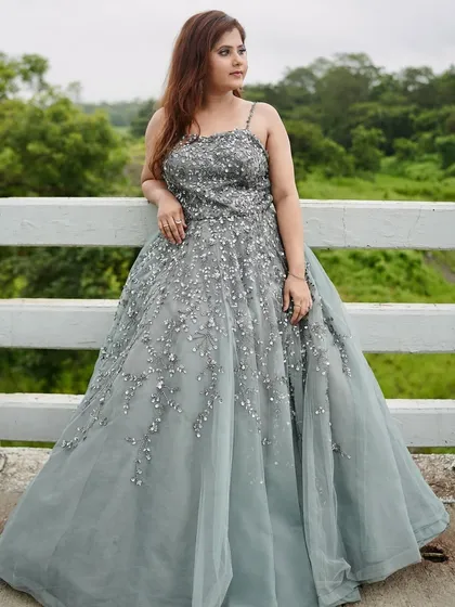 This grey-blue gown is a unique and elegant choice. The scattered silver embellishments look like stardust on the tulle skirt.