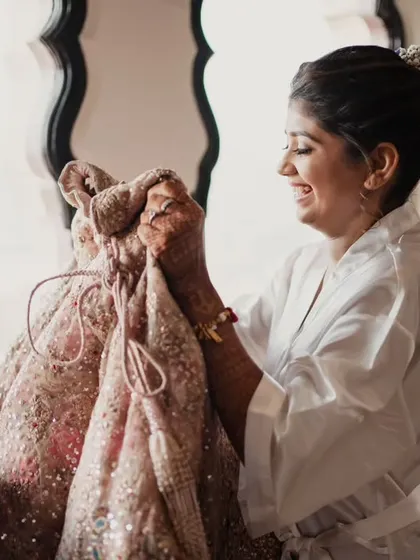 The bride's excitement as she unveils her wedding lehenga. We coordinate every detail, including the special moments of getting ready.