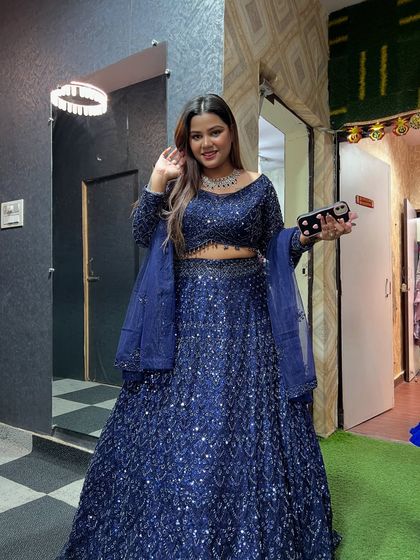 A full-length shot of a client in our fully sequined navy blue lehenga. This is a perfect outfit for a cocktail or reception night.