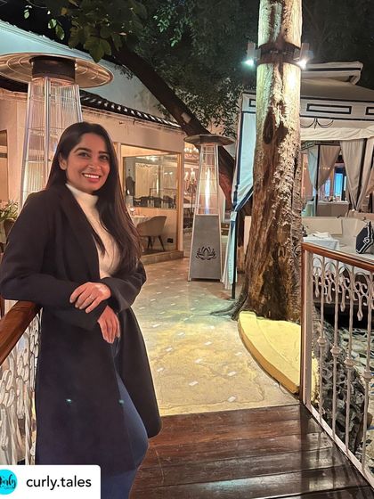 A happy guest posing on our terrace. The multi-level layout with its white balustrades provides a beautiful backdrop for photos.