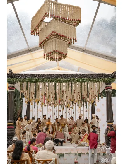 A duplicate of 311, capturing the grandeur of the ceremony with the full floral installation in view.