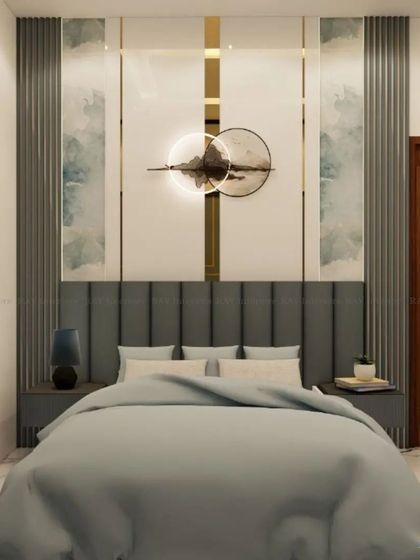 A bedroom with a cool-toned palette, featuring a grey tufted headboard and a modern art piece on the wall.