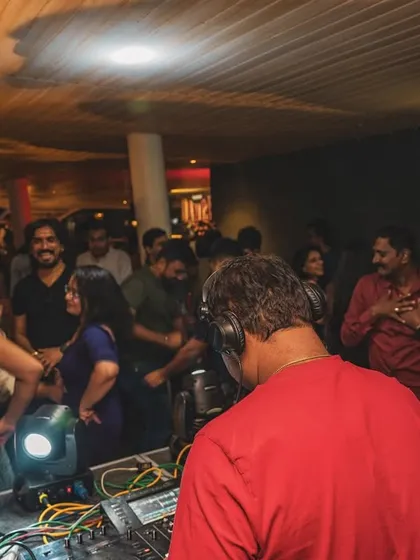 The view from behind a partygoer, looking towards me at the DJ booth.