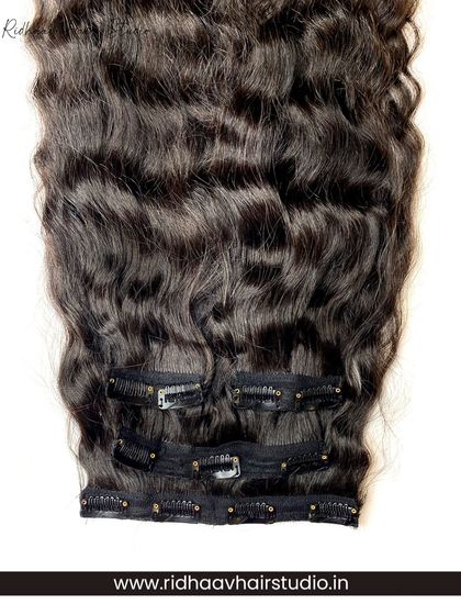 A close-up of the clips on our curly clip-in set. The strong clips provide a secure fit, ensuring your voluminous curls stay in place.