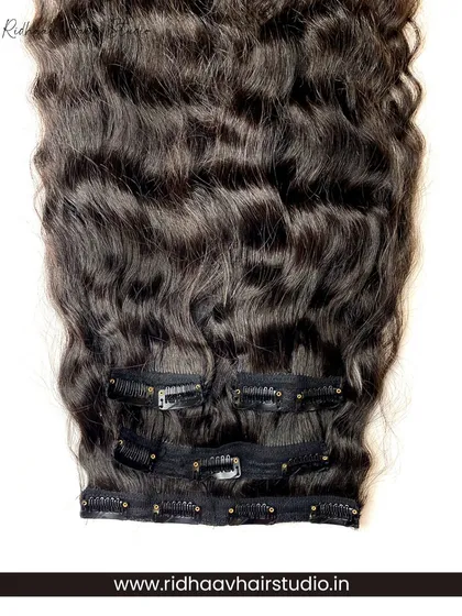 A close-up of the clips on our curly clip-in set. The strong clips provide a secure fit, ensuring your voluminous curls stay in place.