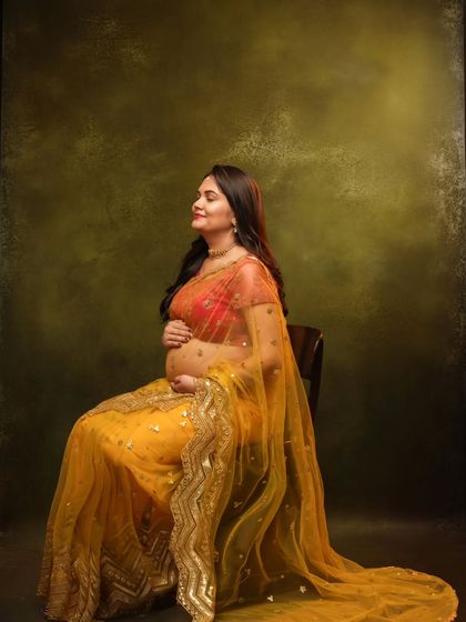 A peaceful, seated portrait of the mom-to-be, her eyes closed in a moment of serene contemplation.