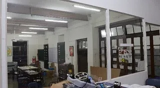 Another 'before' shot, showing the makeshift divisions that had been installed over the years, obscuring the building's grand proportions.